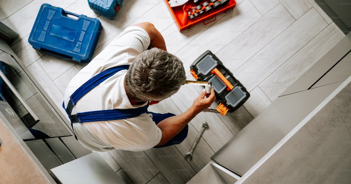 Licensed plumber working with professional tools at a residential property